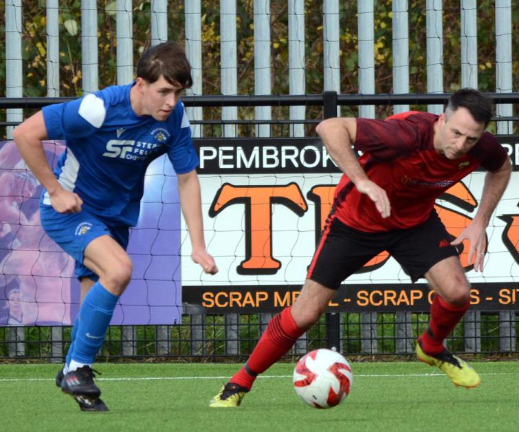 Bridge goal scorer Tomos Gwilliam closely marked by Clarby player manager Matthew Ellis. Picture Gordon Thomas Bridge goal scorer Tomos Gwilliam closely marked by Clarby player manager Matthew Ellis. Picture Gordon Thomas